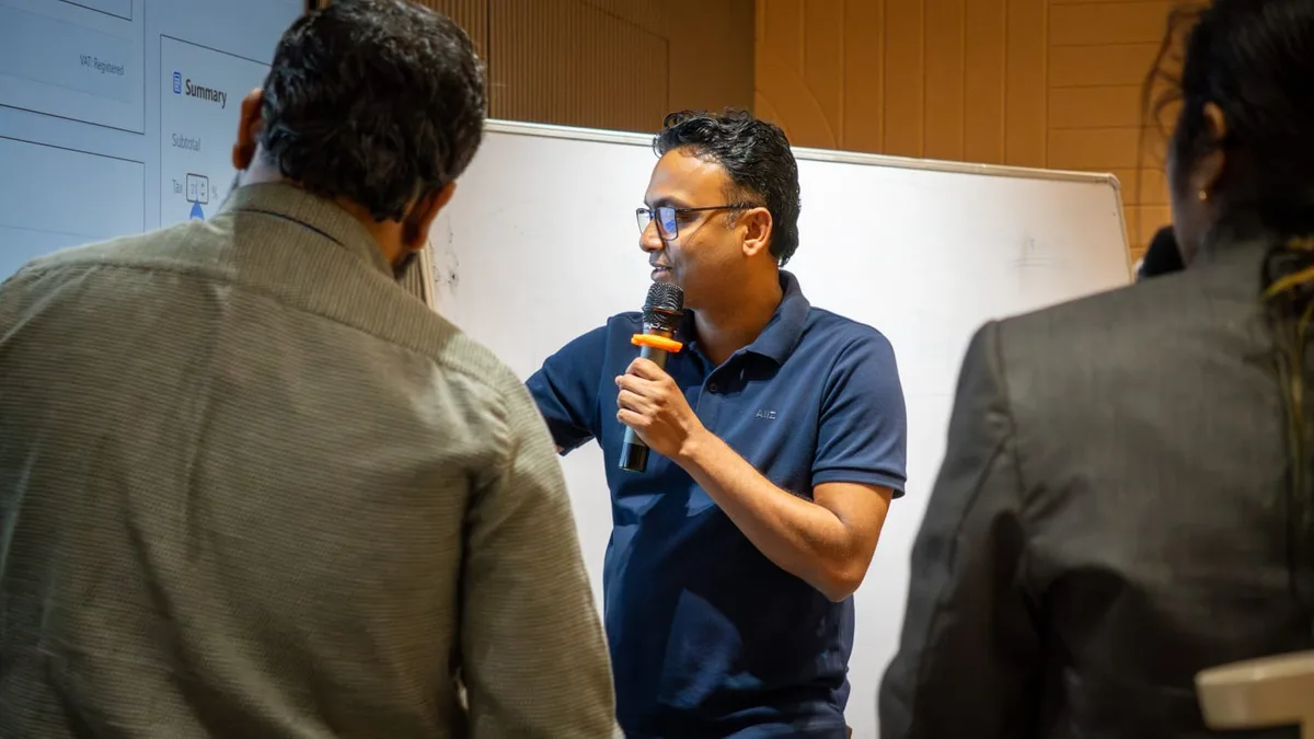 Rakesh Mondal demonstrating an AI-built billing and invoice app to students at a college AI workshop