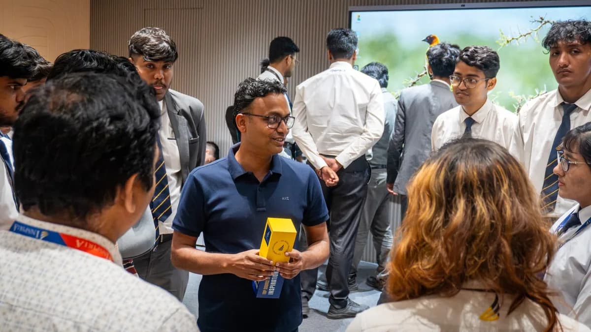 Rakesh Mondal talking with college students after an AI workshop